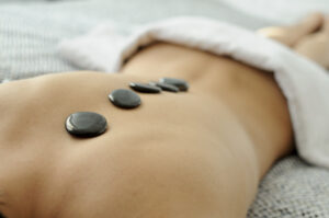 close-up-woman-s-back-with-hot-stones-treatment